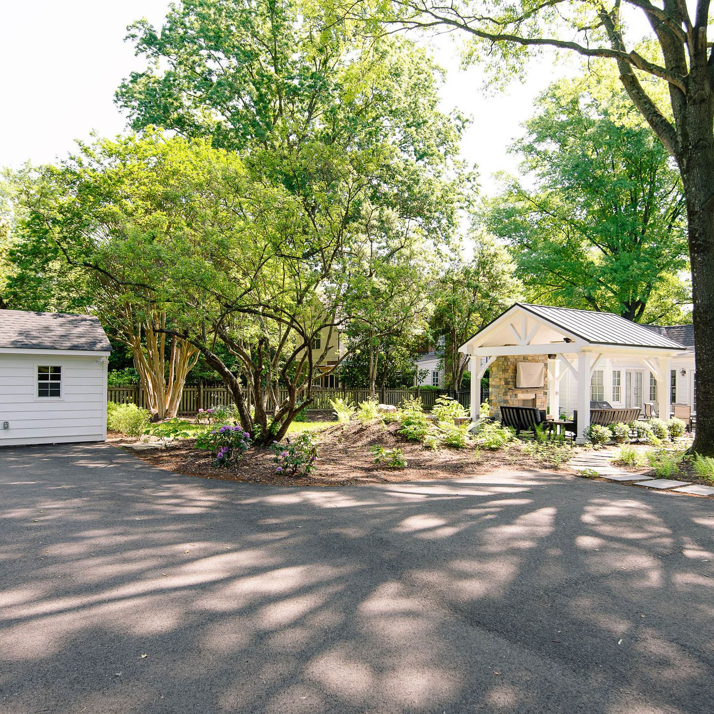 driveway with parking area, custom shed, powder-coated aluminum fence