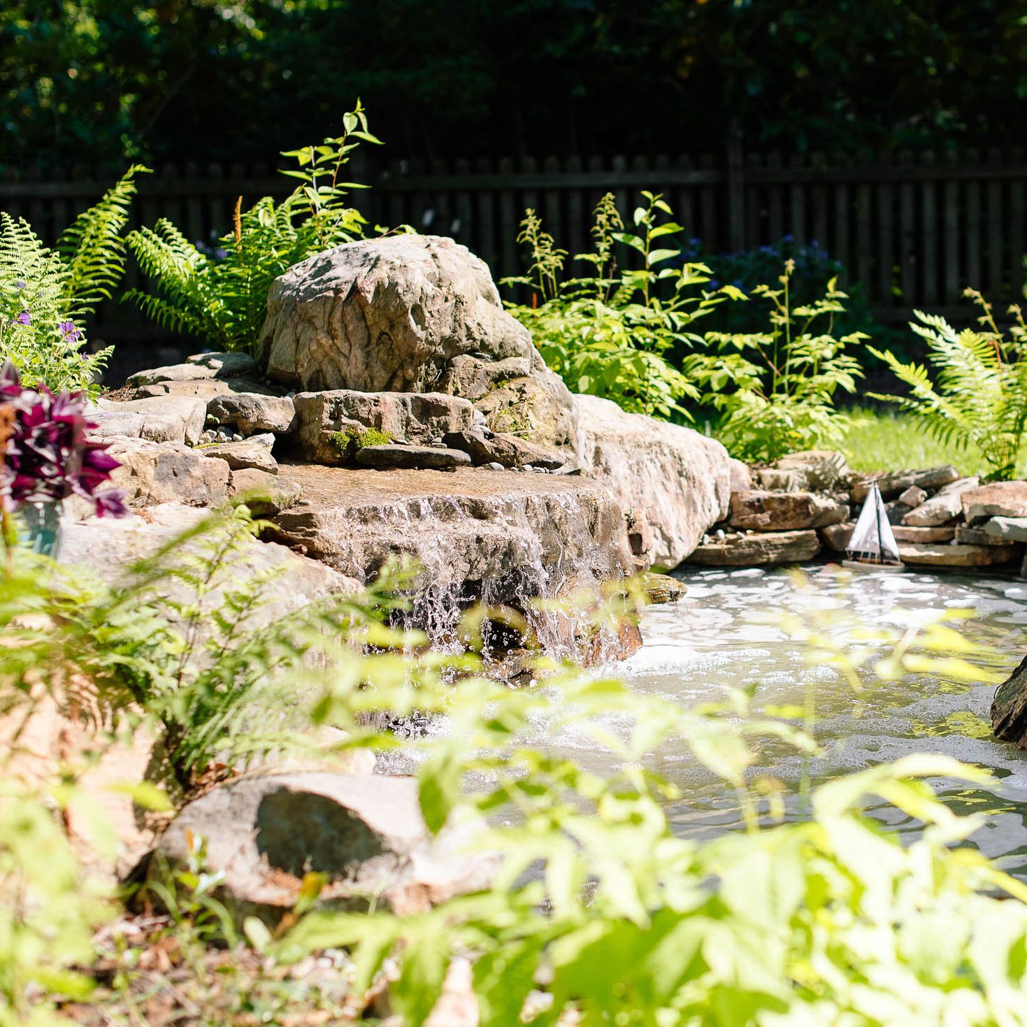 Backyard pond with waterfall feature installed