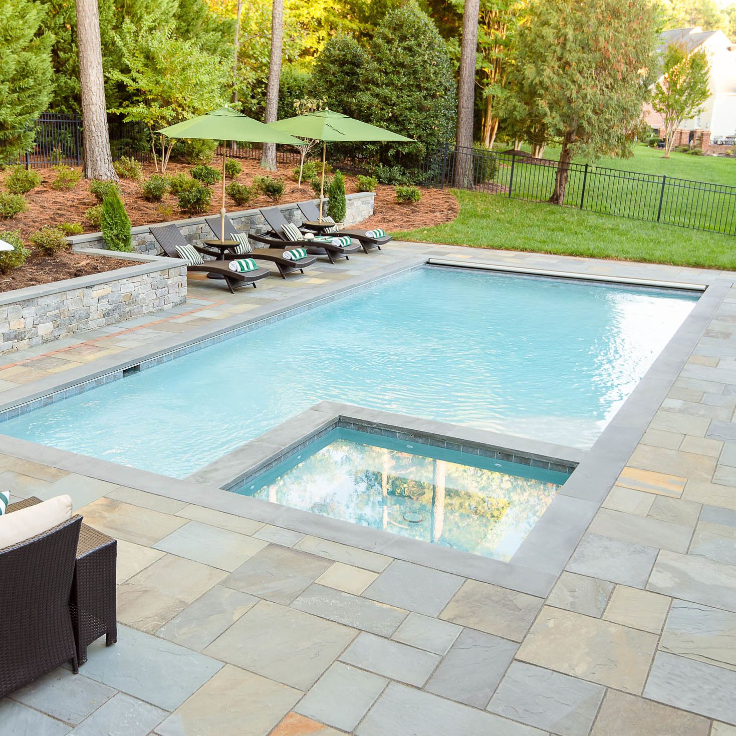 Underground pool installed with one corner of the pool turned into a hot tub