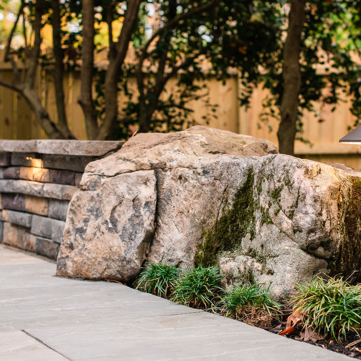 Large boulder used as a boundary line on back patio to start the knee wall