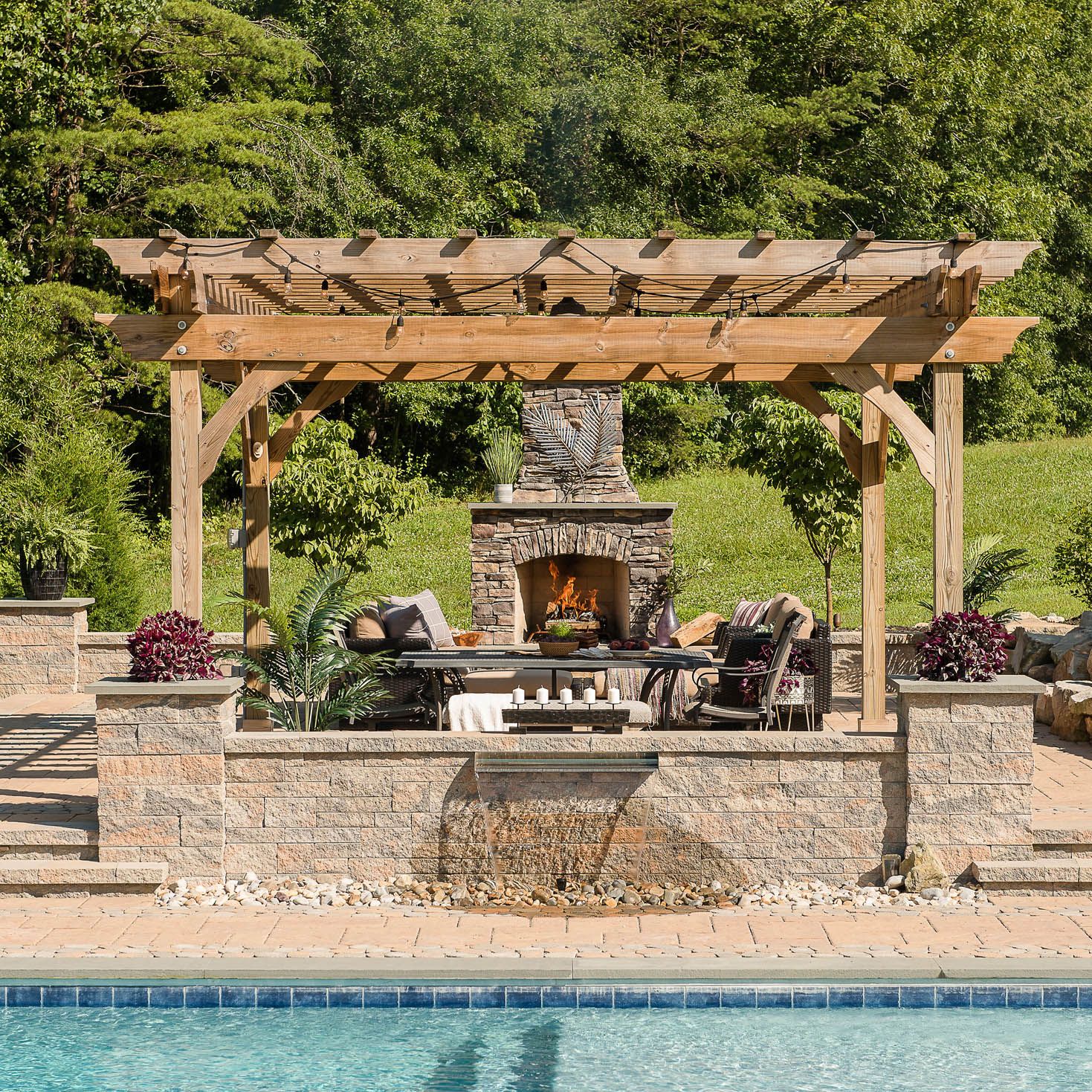 Gunite pool with paver pool decking,outdoor fireplace, wall fountain, and pergola