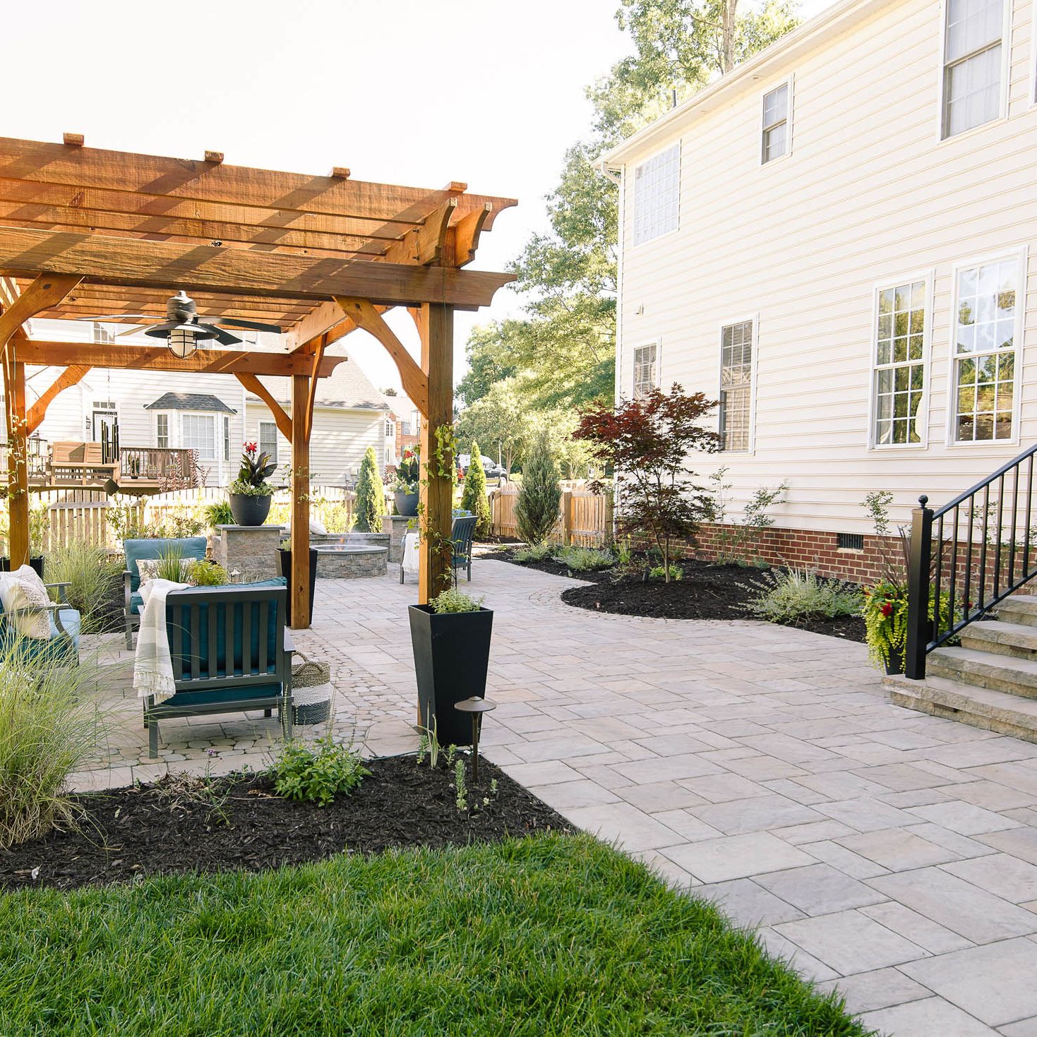 Relaxing backyard patio with sitting area under a stained pergola