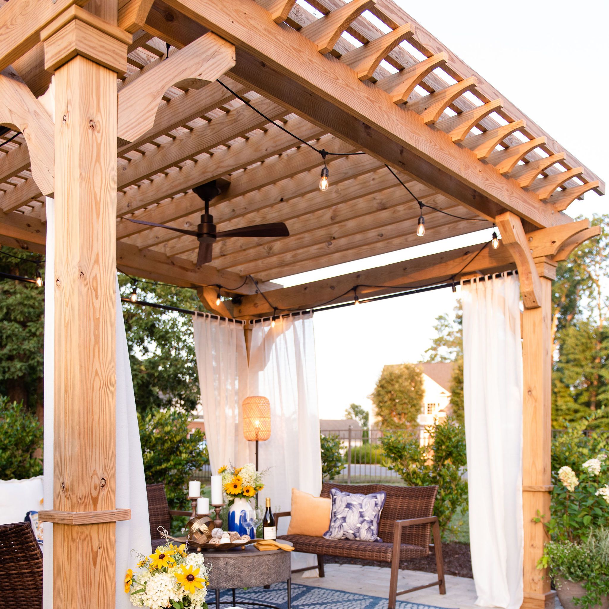 Pergola covered paver patio with fan and lounge area