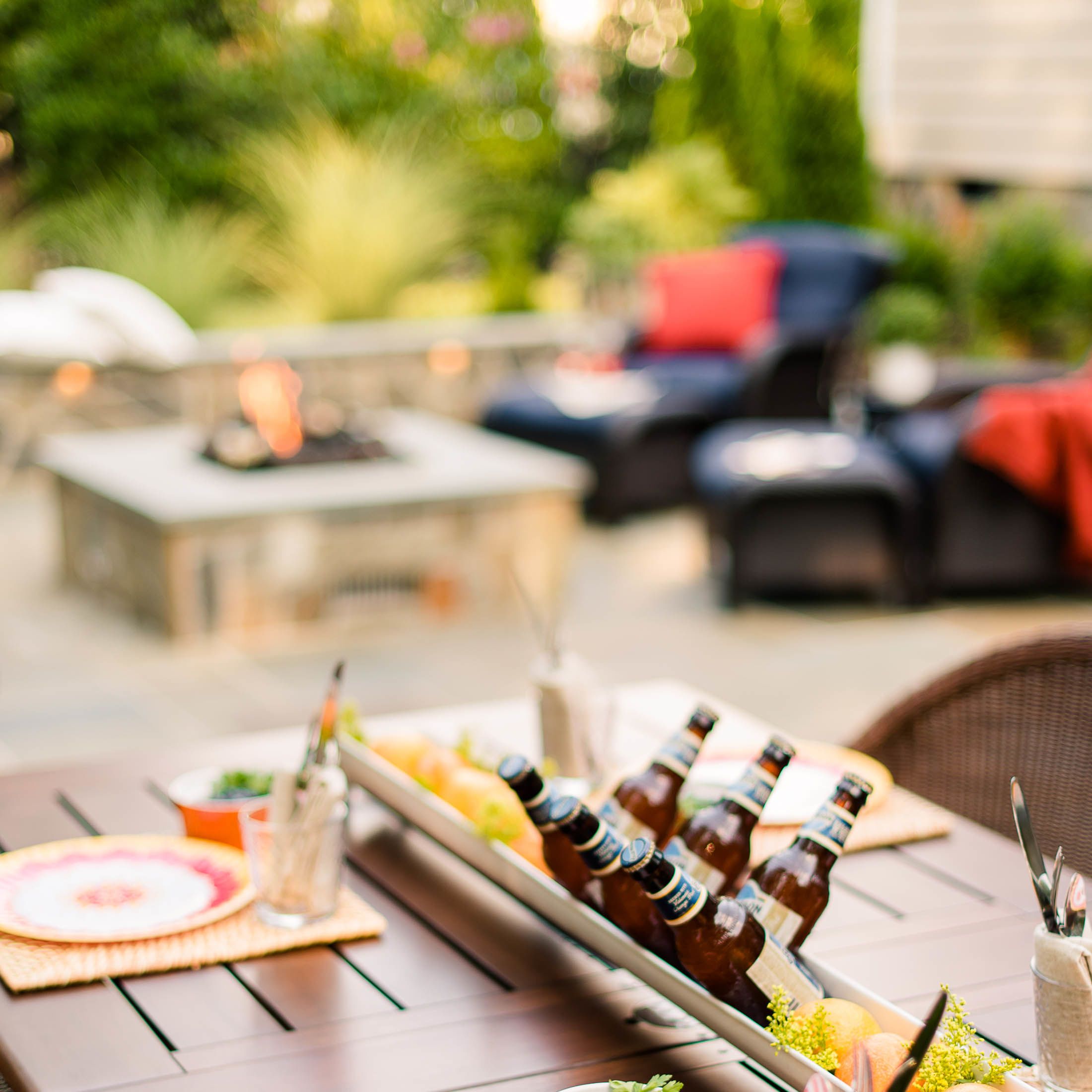 outdoor Table set for social gathering with fire roaring in the fire pit nearby