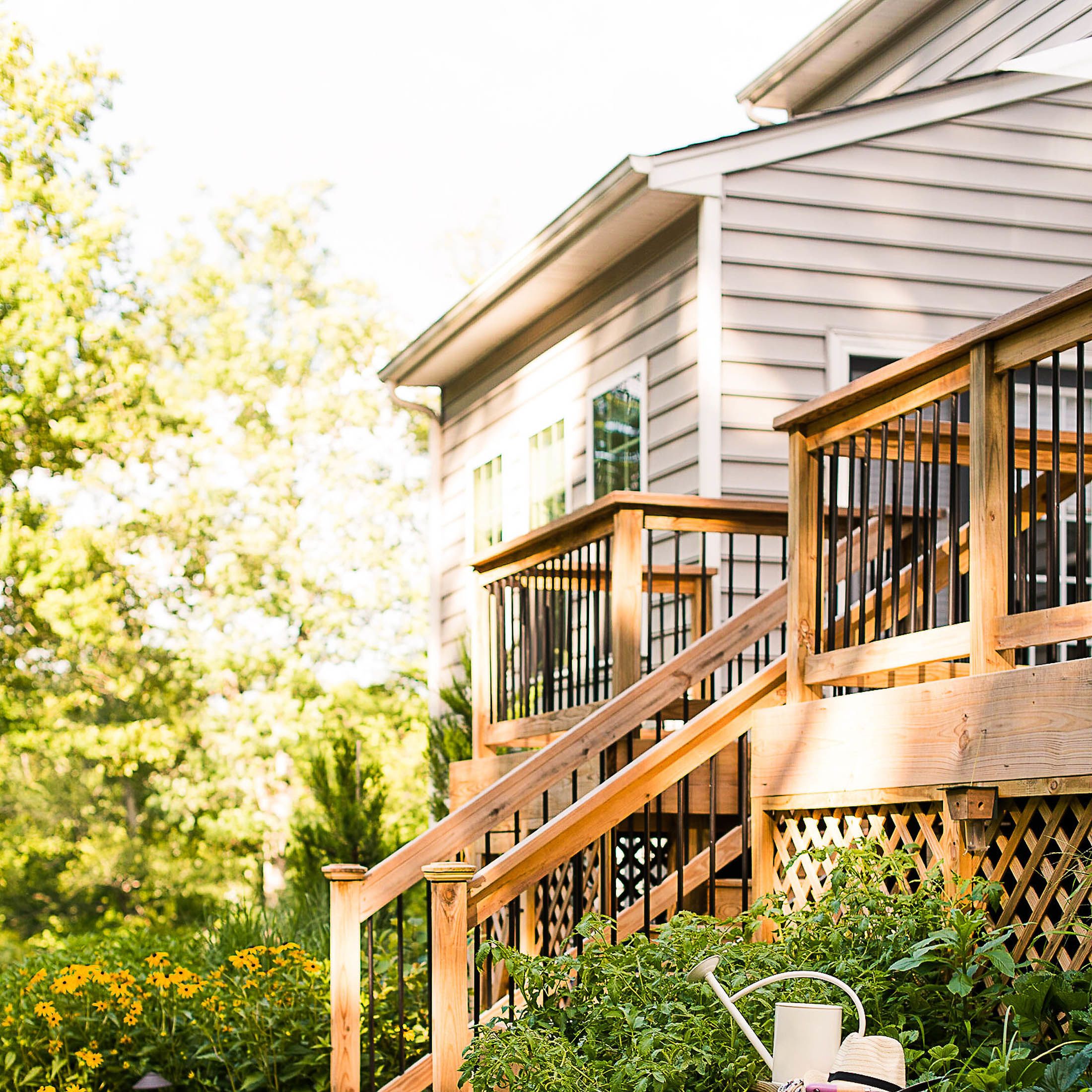 2-tiered Backyard wooden deck leads into herb garden