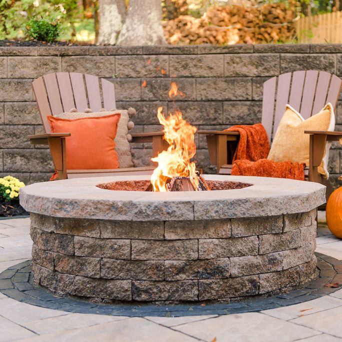 built in stone patio fire pit by retaining wall