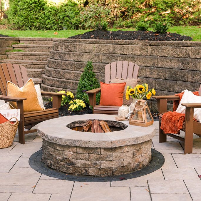 retaining wall and custom stone patio pavers and built-in fire pit