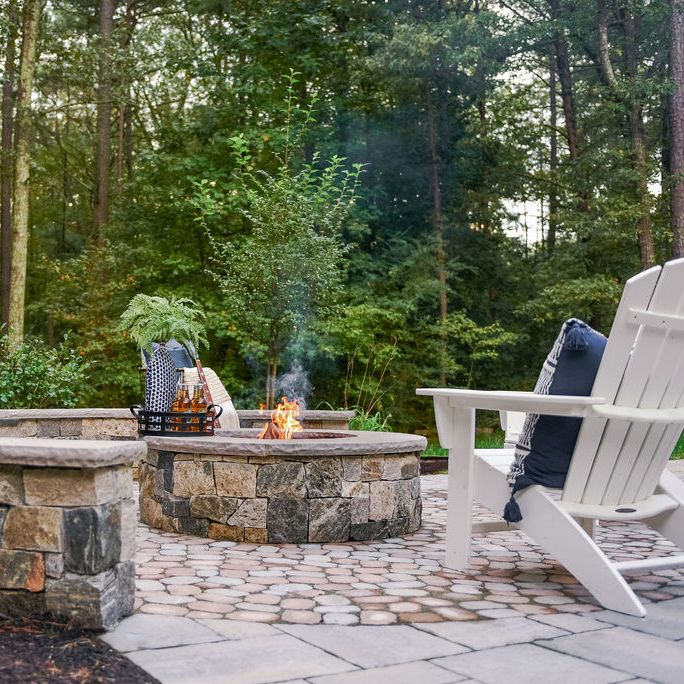 paver patio with stone veneer fire pit and sitting wall